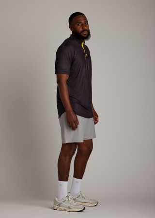Snake skin pattern bladed collar polo shirt in performance fabric for modern athletic style.