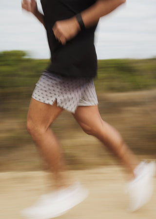 Black fade active shorts with elastic drawstring, versatile fabric, and zippered mesh pockets.