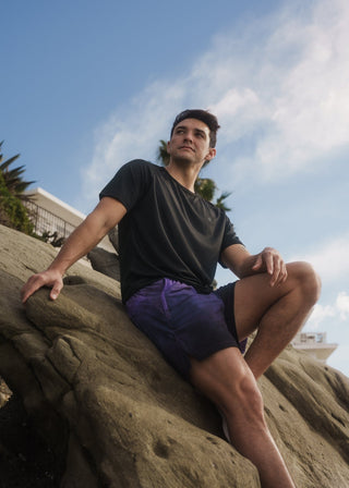 Close-up detail of the black active tee's stretch fabric.
