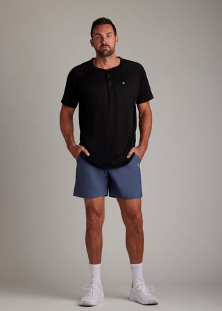 Black 3-button sport tee with modern collar, breathable micro-mesh fabric for active wear.