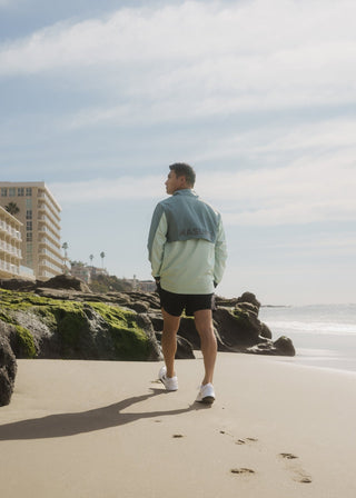 Smooth, water-resistant Taylor Day greens quarter zip windbreaker.