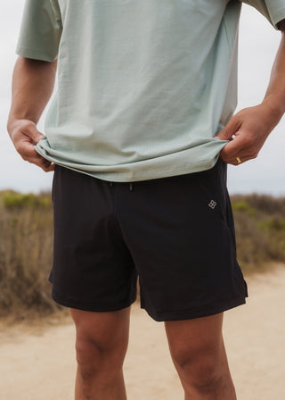 Black hyper-breathable active shorts with elastic drawstring waistband for running and training.