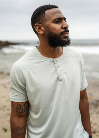 Green 3-button polo tee in breathable micro-mesh fabric, ideal for active game wear.